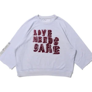 LOVE NEEDS CARE CREWNECK